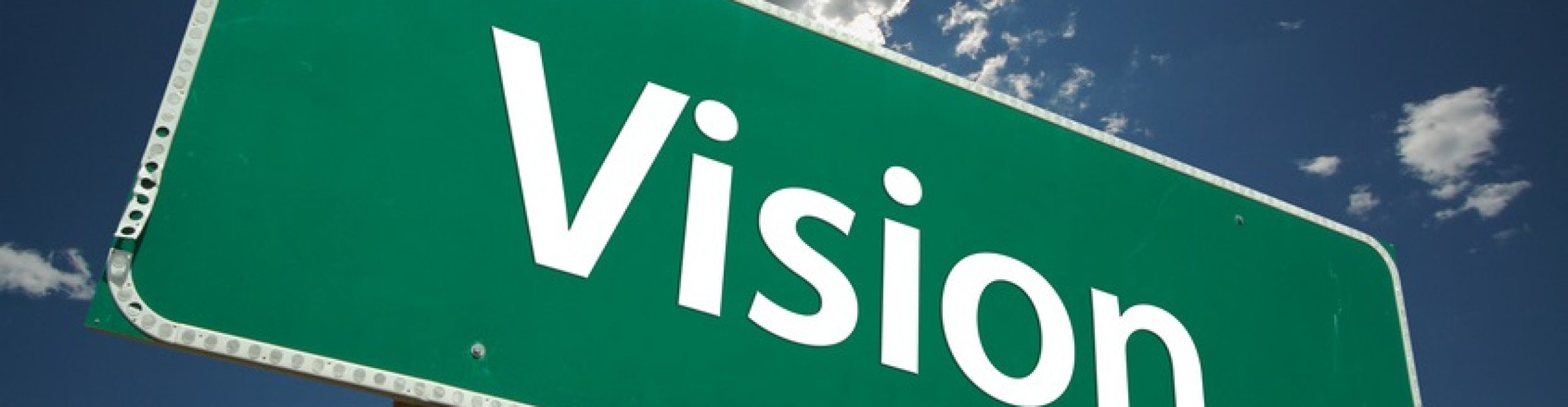 Vision Road Sign with dramatic blue sky and clouds.